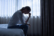 © kieferpix - Depressed Woman Sitting on Bed by Window – Mental Health, Anxiety and Emotional Stress Concept