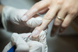 © Nazile - In a beauty salon, a manicurist is performing a machine-based dry manicure on a client's nails (Stock Photo).