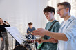 © New Africa - Teenage band practicing their performance with music teacher indoors