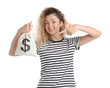 © New Africa - Happy woman pointing at bag full of money on white background