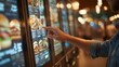 © InfiniteStudio - User interacts with digital menu at fast food restaurant kiosk during busy lunch hour