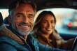 © btiger - Two people in a car at golden hour, cozy denim and leather jackets, relaxed and content while driving with warm bokeh lights outside