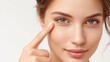 © Formoney - Woman with a green eye is pointing at her face. She has a nice smile and her eyes are bright