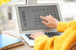 © Pixel-Shot - Female hands using laptop with calendar at table, closeup