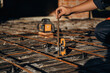 © standret - On metal rods. Close up view of man's hand that is using leveling tool on the floor, construction site