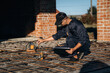 © standret - Builder is working on construction site, unfinished building