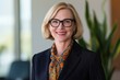 © Arfa_Media - Confident businesswoman smiling broadly, showcasing leadership, success, and a friendly corporate demeanor while working in a bright office environment