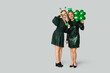 © Pixel-Shot - Beautiful women with clovers on light background. St. Patrick's Day celebration
