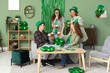 © Pixel-Shot - Group of people with beer at home on St. Patrick's Day