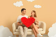 © Pixel-Shot - Young couple with heart sitting on sofa in clouds near beige wall