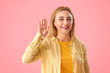 © Pixel-Shot - Mature woman with drawn gender symbols on pink background