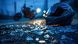 © Mikhail Vorobev - Motorcycle helmet on asphalt surrounded by shattered glass fragments with blurred bike headlights shining in the evening background urban scene