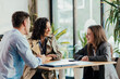© Suteren Studio - Coworkers enjoying coffee break and relaxed conversation