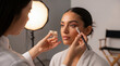 © jockermax3d - Makeup artist applying eye makeup to a woman