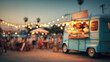 © Sabana - A blue food truck parked at an outdoor festival with string lights