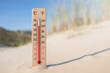 © Tomas Ragina - Wooden celsius and fahrenheit scale thermometer in the sand. Ambient temperature plus 40 degrees
