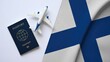 © Asim - An international passport and a toy airplane are placed on a Finland flag.