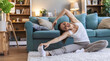 © Jelena Stanojkovic - Woman, stretching and fitness for flexibility, exercise and getting ready for morning. Girl, yoga warm up and start training in home living room for wellness, health and balance or pilates workout