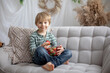 © Tomsickova - Cute preschool child, boy, eating strawberries at home
