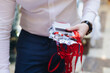 © tsuguliev - Checking in on conference congress forum event, registration desk table, visitors and attendees register electronic ticket and receiving red lanyard with name badge and entry wristband bracelet