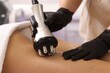 © New Africa - Woman undergoing cellulite treatment with radio frequency machine in salon, closeup