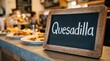 © DavoeAnimation - Small Chalkboard Sign with Quesadilla Text in Cafe