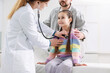 © New Africa - Little girl and her father having appointment with pediatrician in hospital. Doctor checking child with stethoscope, closeup