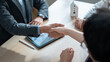 © Yingyaipumi - Close up of a real estate agent and client shaking hands for a successful home insurance deal or property mortgage. Concept of house buying, financial agreement, and investment security at office