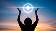 © MstZulakha - Silhouette of person reaching for glowing orb in sunset sky