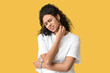 © Pixel-Shot - Young African-American woman suffering from skin allergy on yellow background