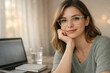 © Aleksandra - Woman with glasses working at laptop in cozy home office setting