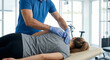 © Jai Izzam - Faceless male physiotherapist wearing blue medical gloves performing manual back massage on woman