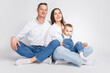 © danmorgan12 - Adorable Smiling Happy Caucasian Parents Mom and Dad With Little Son Child Kid Boy On Casual Jeans Clothing  Hugging Gladly Together Over White