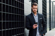 © Westend61 - Young businessman looking at his smartphone