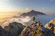 © Westend61 - Hiker admiring awesome view while standing on mountain peak at Bergamasque Alps, Italy