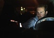 © Westend61 - Young man in car at night