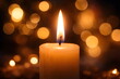 © Anastasiia - Burning candle with warm golden bokeh lights in the background creating a peaceful and cozy atmosphere.