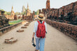 © Soloviova Liudmyla - Young woman tourist walking with compact photo camera through Ayutthaya Wat Phra Ram ancient ruins in Thailand. History, tourism, sightseeing concept.