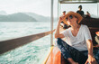 © Soloviova Liudmyla - Young woman traveler in straw hat and sunglasses sitting on longtail boat enjoying scenic view of Khao Sok National Park Cheow Lan Lake in Thailand during summer vacation trip tropical landscape