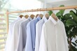© nsit0108 - Clean business shirts organized on a rail, showcasing minimalist fashion and professional style