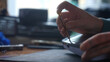 © kinomaster - A detailed view of a person hand using a screwdriver to repair or assemble an electronic device.