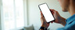 © Pete - Man holds smartphone with blank screen for text or app placement. Person uses phone indoors, connects online. White background copy space for ads.