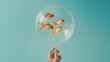© apimagine - A delicate hand holding a transparent balloon with a goldfish swimming inside, creating a whimsical and magical scene.