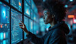 © Pete - Woman in hoodie works with code on multiple monitors. Female programmer analyzes data streams on big screen wall. Modern tech office displays information.