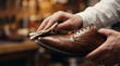 © Eduardo Accorinti - Man polishing luxury leather dress shoe by hand in elegant workshop, close-up with profile view
