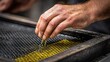 © YanabY - Hand pressing oil from olives in a workshop during the day in a rural area