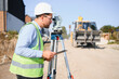 © Serhii - Surveyor using theodolite for land measurement at construction site