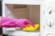 © Todayphoto - Cleaning old dirty microwave from grease, soot. Microwave oven switches. Kitchen cleaning concept.