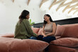 © Wavebreak Media - Large plush sectional sofa is anchoring bright lounge with dusty rose cushions and exposed beams