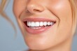 © Irina Ukrainets - A close-up shot of a beautiful woman smiling brightly. Her flawless white teeth shine against a soft background. This image captures joy and confidence. Perfect for beauty and dental advertising. AI